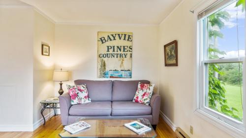 a living room with a couch and a window at Bayview Pines Country Inn B&B in Mahone Bay