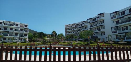 a pool in front of some apartment buildings at Studio de luxe avec piscine in Tétouan