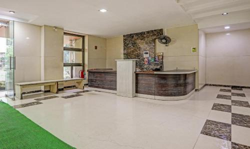 a lobby with a bar and a green floor at Treebo Trend Welcome Apartments in Mumbai