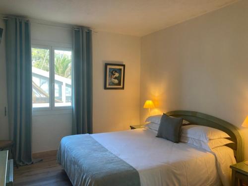 Postel nebo postele na pokoji v ubytování Hotel la Caravelle