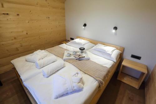 a bedroom with two beds with white sheets and a tray with towels at Healthy House Glamping in Koper