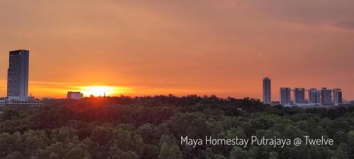 a sunset over a city with trees and buildings at Maya Homestay Putrajaya @ Twelve in Putrajaya
