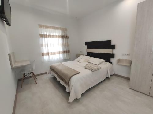 Cama o camas de una habitación en Hostal Óleo Auto Check-in
