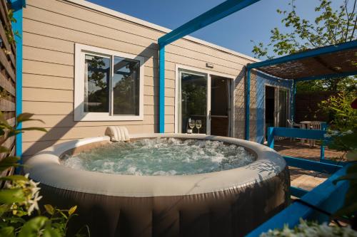 a hot tub in the backyard of a house at Agriturismo L'Acero Rosso in Sacile