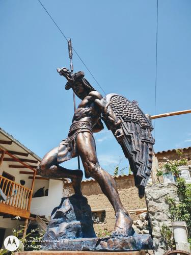 a statue of a man holding a spear at Casona Mollepata in Mollepata