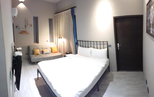 a bedroom with two beds and a couch at 82行旅 加Line享優惠 in Jian
