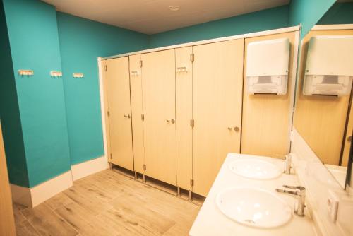 a bathroom with a sink and a mirror at La Flamenka Hostel in Seville