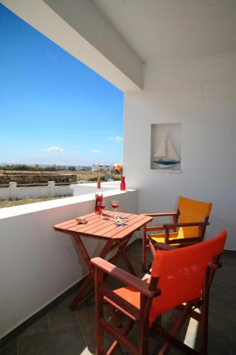 a dining room with a wooden table and chairs at Irida Vacation suites in Kastraki Naxou