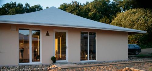 a white house with a pitched roof at Wilja in Friedenstal