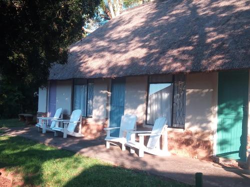 a group of chairs sitting outside of a house at Ledges Retreat in Bergville