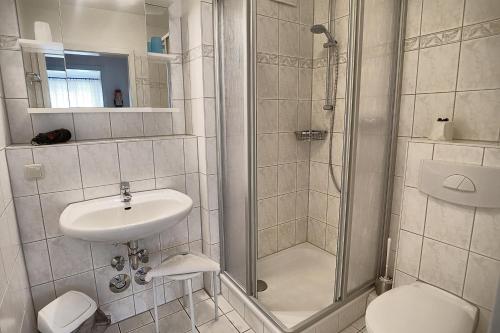 a bathroom with a shower and a sink and a toilet at Residenz "Am Strand", Whg 8 in Zingst