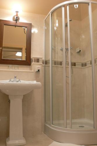 a bathroom with a shower and a sink at Öreg Miskolcz Hotel in Miskolc