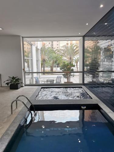 a swimming pool in the middle of a building at H2 Platinum Lourdes in Belo Horizonte