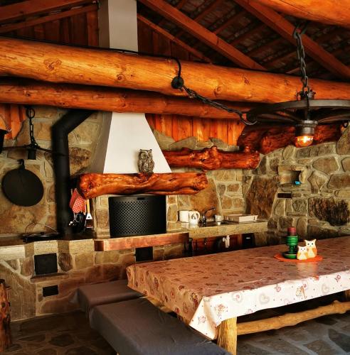 a dining room with a table in a log cabin at Penzion U Sovy in Dolný Kubín