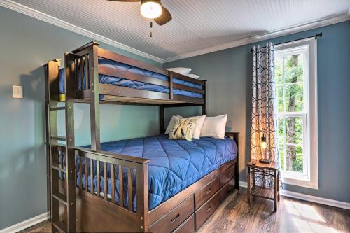 a bedroom with a bunk bed and blue walls at Waterfront Gem on Lake Sinclair with Boat Dock! in Resseaus Crossroads