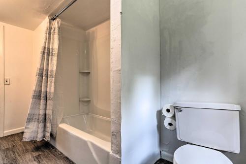 a bathroom with a toilet and a bath tub at Spacious Sullivan County House with Fire Pit in Hurleyville