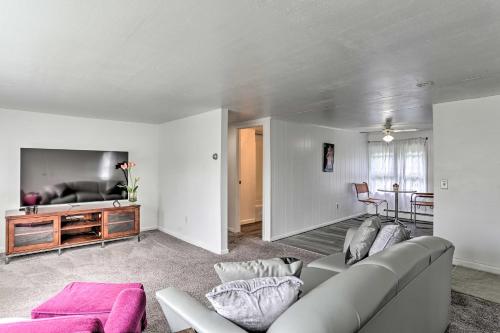 a living room with a couch and a tv at Spacious Sullivan County House with Fire Pit in Hurleyville