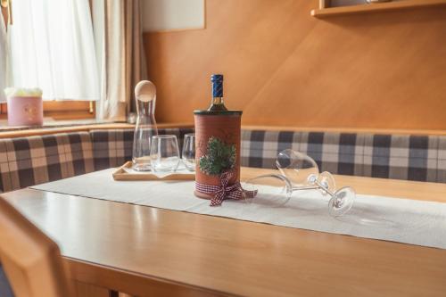 a bottle of wine sitting on a table with glasses at Appartement Stadler in Bad Hofgastein