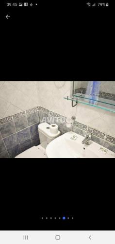 a bathroom with a toilet and a sink at Studio de luxe avec piscine in Tétouan