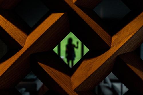 a picture of a person standing behind a wooden fence at Linder Cycling Hotel in Selva di Val Gardena