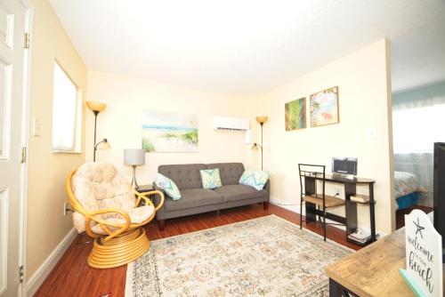 a living room with a couch and a table at Cozy Canaveral Beach Condo! Next to NASA Launch Site in Cape Canaveral