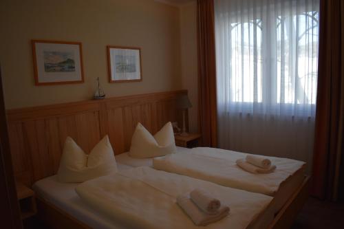 a hotel room with two beds with towels on them at Villa Carina "Carina`s 911" in Baabe