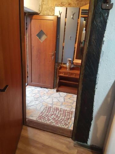 a door leading to a hallway with a mirror at Apartment Ema in Žukalj