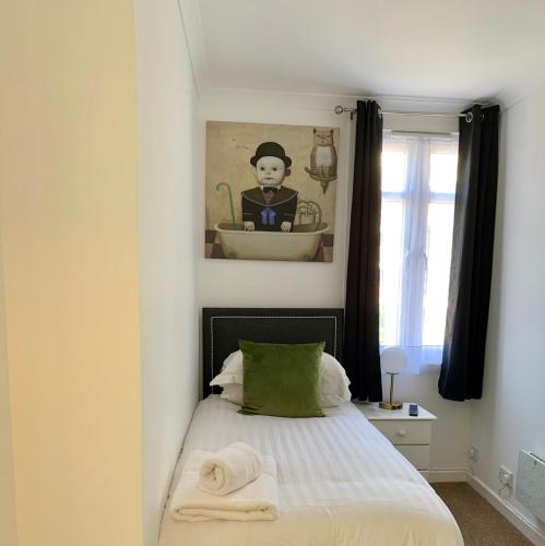 a bedroom with a bed with a sink and a bath tub at Sarum Apart-Hotel in Saint Helier Jersey
