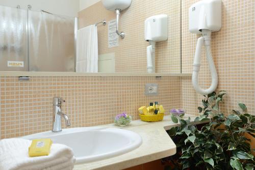 a bathroom with a sink and a mirror at Hotel Oasis in Alghero