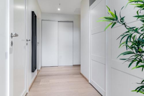 a hallway with a door and a plant at MJOS TOWER Apartment - Lovely city view in Ringsaker