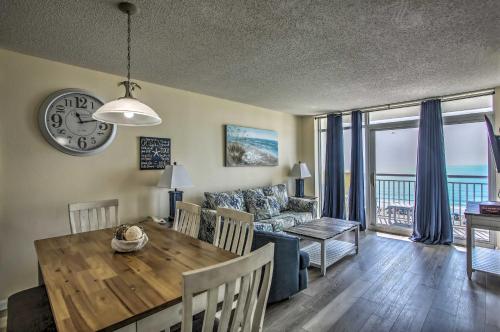 a dining room and living room with a table and a couch at Bay Watch Condo with Oceanfront Balcony and Beach View in Myrtle Beach