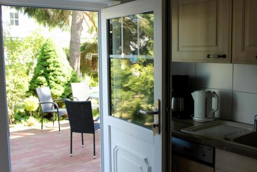 a kitchen door with a view of a patio at Strandvilla Sophie App 1 in Dierhagen