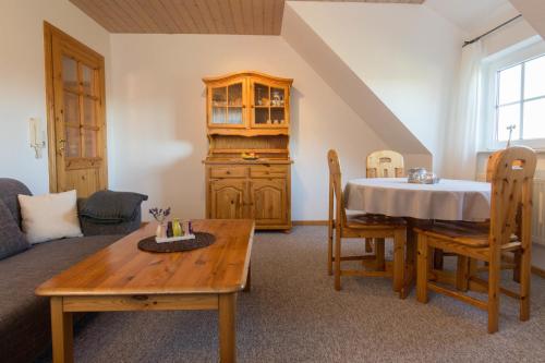 a living room with a table and a couch at Ferienhof Böhnke Nr4 in Puttgarden