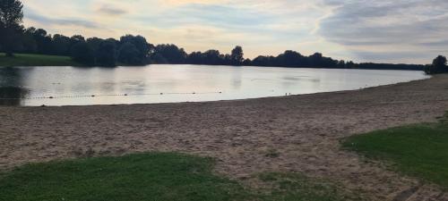 a large body of water with trees in the background at Hotel Zur Aue in Wesel