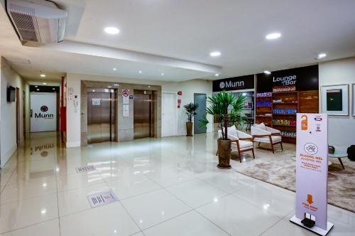 a lobby of a store with tables and chairs at Go Inn Contagem - MG in Contagem
