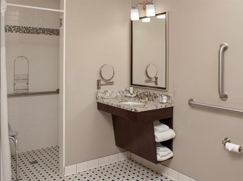 a bathroom with a sink and a shower at The Bolling Wilson Hotel in Wytheville