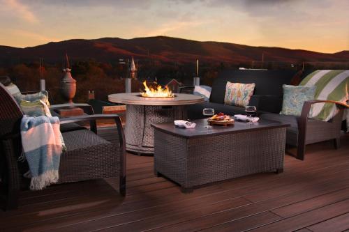 a patio with a table and chairs and a fire pit at The Bolling Wilson Hotel in Wytheville