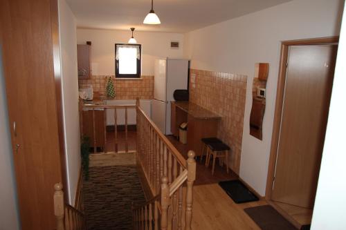 a staircase leading to a kitchen and a living room at Pokoje U Hanki in Szczawnica