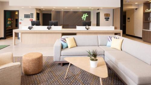a lobby with a couch and a waiting room at Holiday Inn Santa Ana-Orange Co Arpt by IHG in Santa Ana
