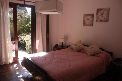 1 dormitorio con cama y ventana grande en DEPARTAMENTO FAMILIAR en Mar del Plata