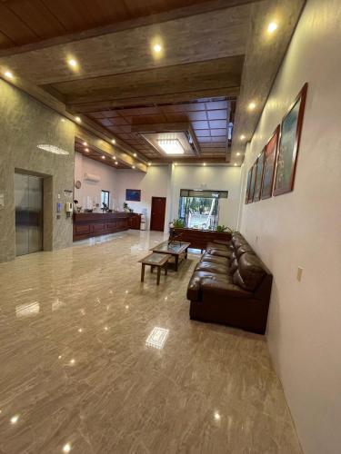 a large lobby with a couch and a table at Coral View Hotel & Resort in Caye Caulker