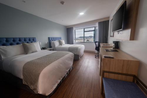 Postel nebo postele na pokoji v ubytování TRYP by Wyndham Guayaquil Airport