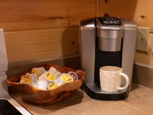 a cup of coffee next to a coffee maker at On the River Wooded Bliss Cabin near Loloma in McKenzie Bridge