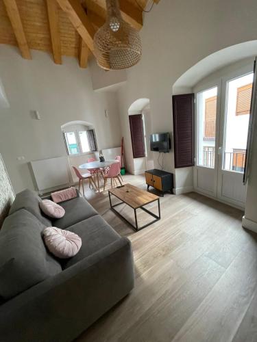 a living room with a couch and a table at La Rua 25 in Castro-Urdiales