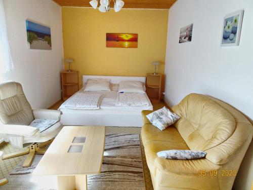 a bedroom with a bed and a couch and a table at Theil, Wolfgang in Zingst
