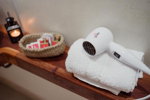 a hair dryer and a basket on a shelf at Luna de Cafayate Hotel Boutique in Cafayate