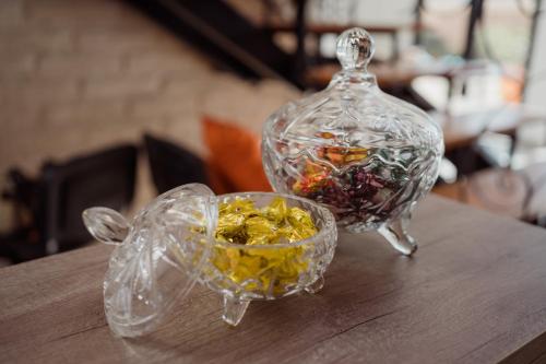 two glass containers sitting on top of a wooden table at Luna de Cafayate Hotel Boutique in Cafayate