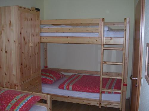 a bunk bed with a ladder in a room at Reiseoase Kavelweg 10, Whg 2 in Zingst