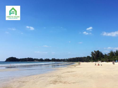 a view of a beach with people on the sand at Tiny house on Koh Lanta only 2 mins walk to the beach in Ban Mo Nae