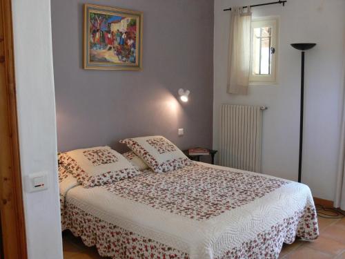 a bedroom with a bed with two pillows at La Coudoulière in Saint-Rémy-de-Provence